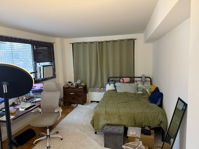 bedroom featuring radiator heating unit and cooling unit