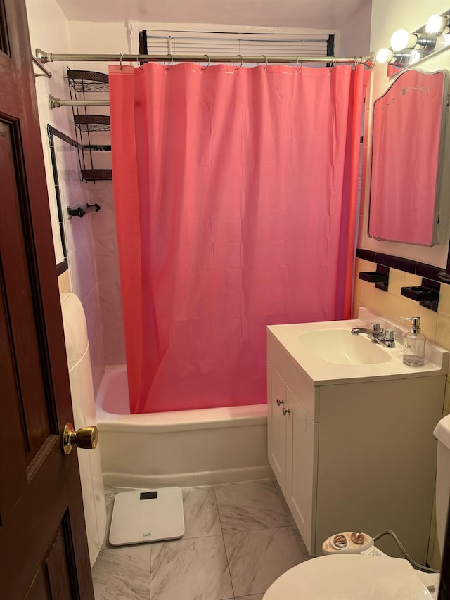 full bathroom with toilet, marble finish floor, shower / tub combo with curtain, and vanity