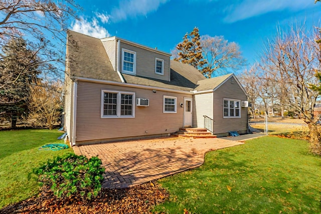 back of house with a yard, a wall unit AC, and a patio