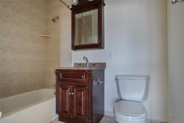 full bathroom with tiled shower / bath, vanity, and toilet