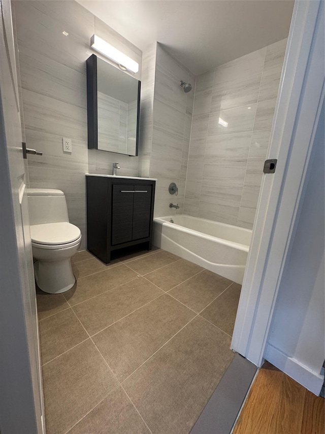 full bathroom featuring toilet, vanity, bathing tub / shower combination, and tile patterned floors