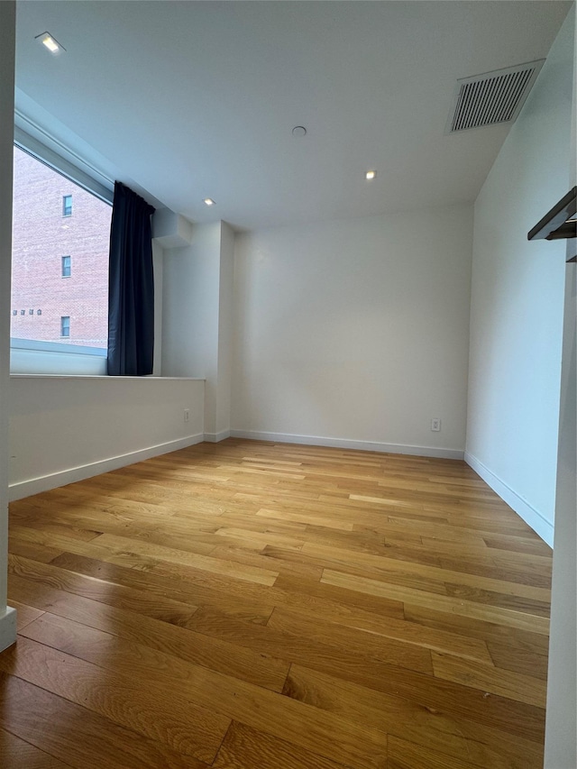 spare room featuring baseboards, recessed lighting, visible vents, and light wood-style floors