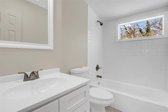 full bathroom with vanity, tiled shower / bath, and toilet