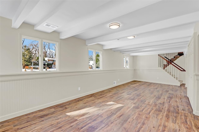 interior space with beamed ceiling and light hardwood / wood-style floors