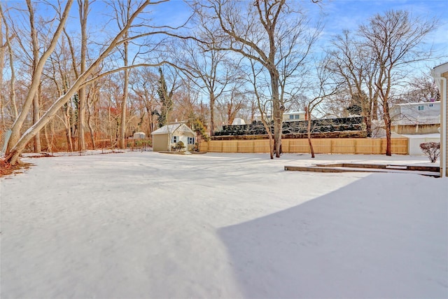 snowy yard with an outbuilding