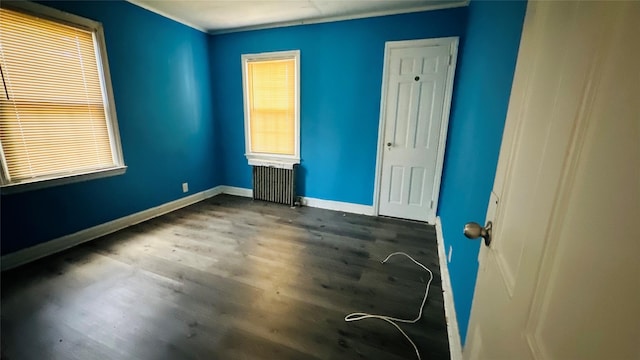 spare room with radiator and wood-type flooring