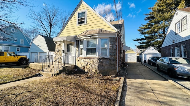 view of front of property featuring a garage and an outdoor structure