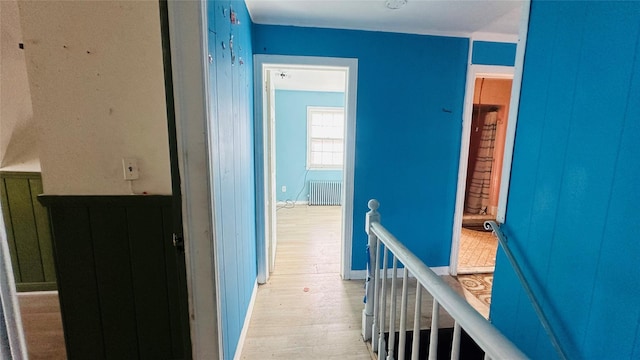 hallway with radiator and light hardwood / wood-style flooring