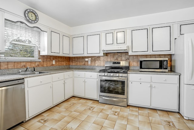 kitchen featuring stainless steel appliances, sink, white cabinets, and backsplash