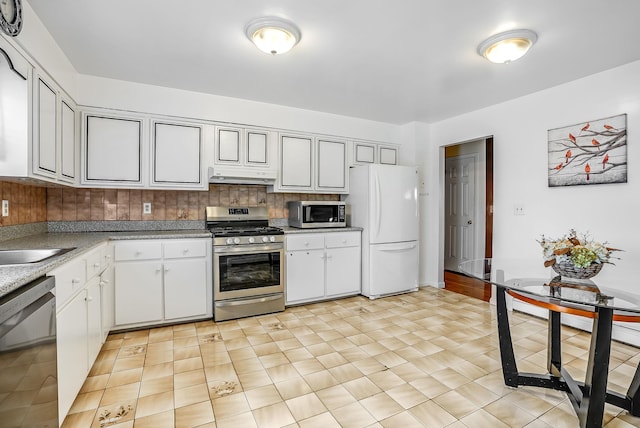 kitchen featuring stainless steel appliances, light tile patterned flooring, sink, and decorative backsplash