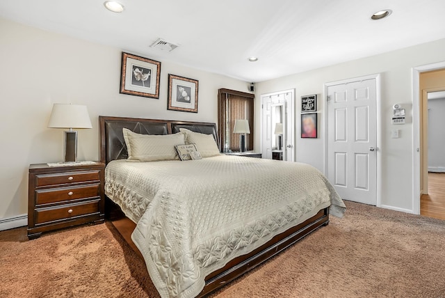 carpeted bedroom with a baseboard radiator