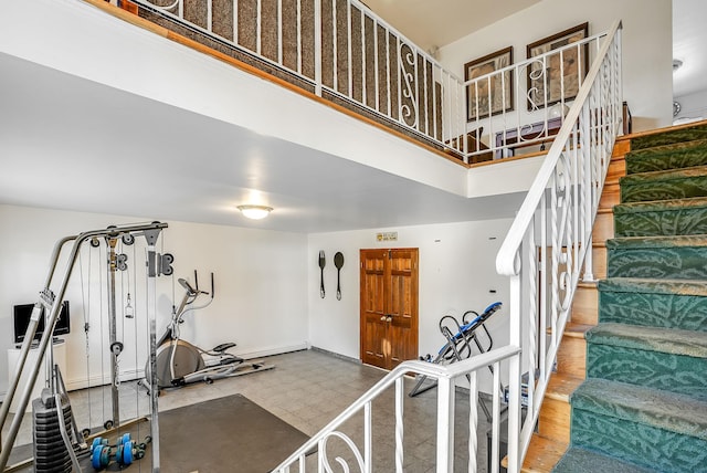 staircase featuring a high ceiling