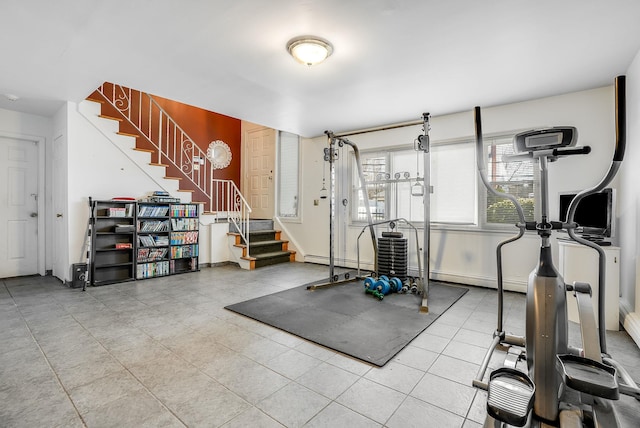 workout area with a baseboard radiator and tile patterned floors