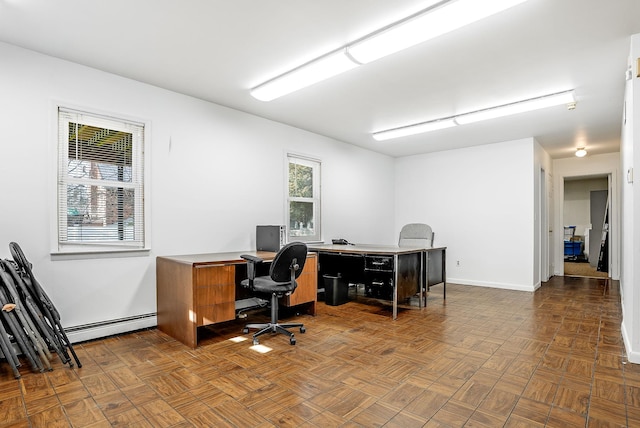 office space featuring baseboard heating and parquet floors