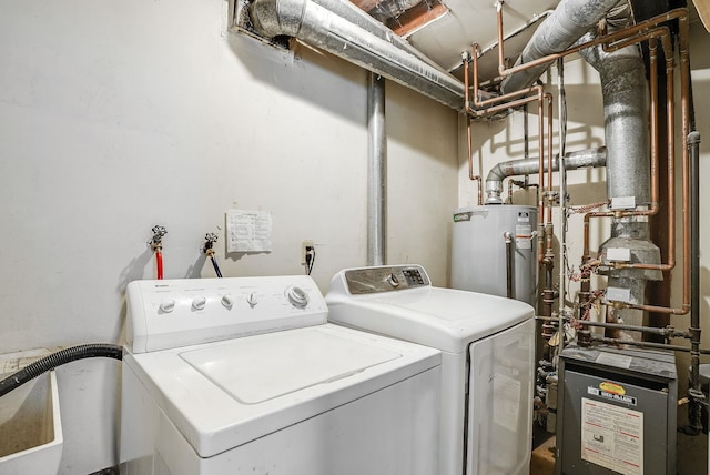 laundry area featuring gas water heater and washing machine and clothes dryer