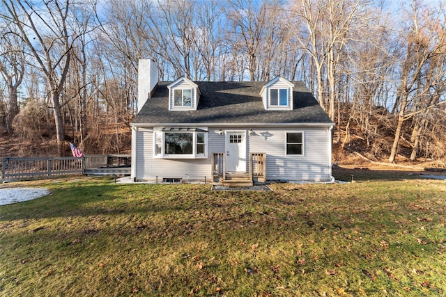 cape cod-style house with a front yard