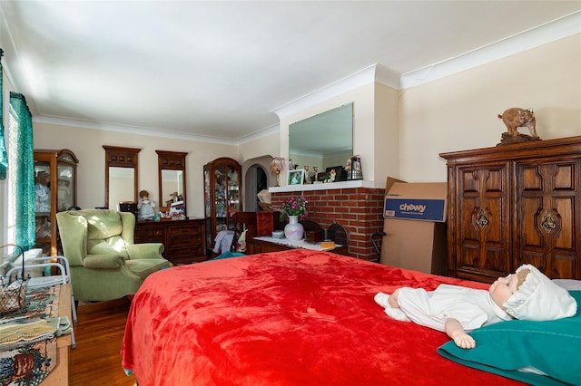 bedroom with wood-type flooring and crown molding