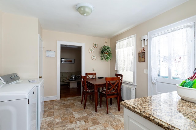 dining room with radiator and washing machine and clothes dryer