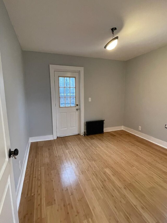 18806 Brinkerhoff Ave, Cambria Heights, NY 11412 - entrance foyer featuring radiator and light hardwood / wood-style flooring