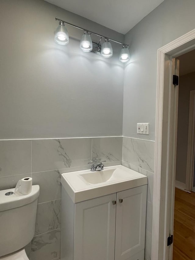 18806 Brinkerhoff Ave, Cambria Heights, NY 11412 - bathroom with vanity, toilet, and tile walls