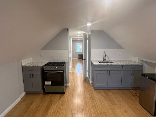 18806 Brinkerhoff Ave, Cambria Heights, NY 11412 - kitchen featuring light stone counters, sink, range hood, and appliances with stainless steel finishes