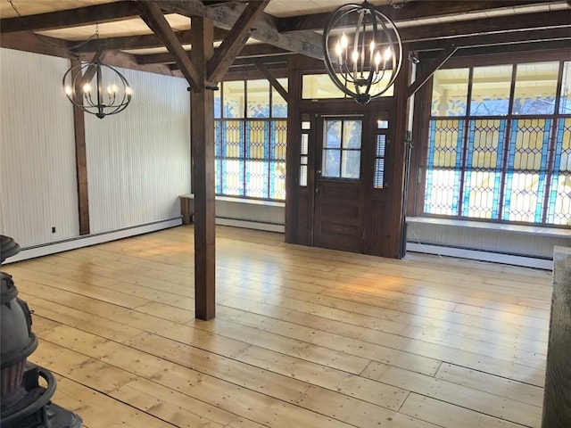 foyer featuring an inviting chandelier, light hardwood / wood-style flooring, and baseboard heating