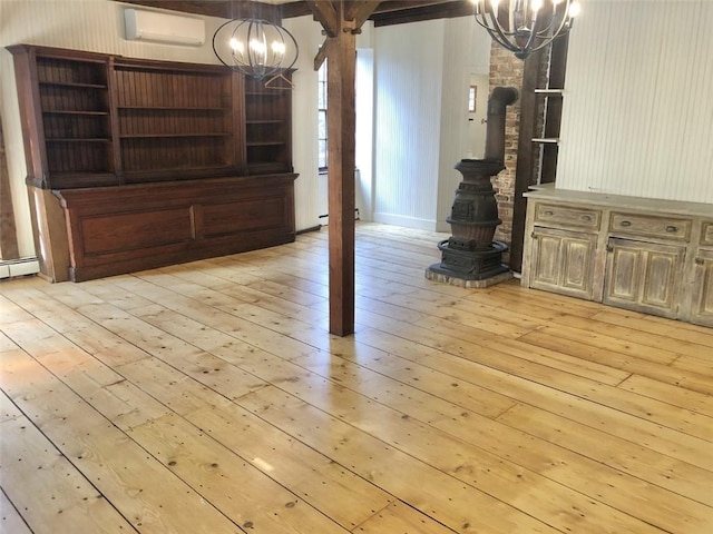 unfurnished dining area with an inviting chandelier, light hardwood / wood-style flooring, a wall unit AC, and a baseboard radiator