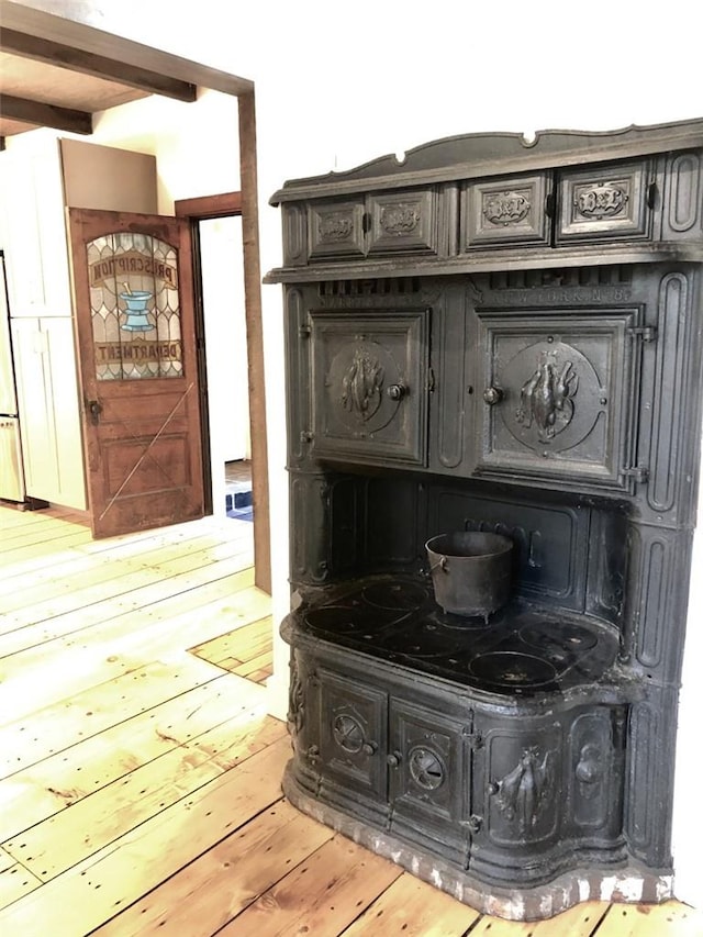 room details with white refrigerator and wood-type flooring