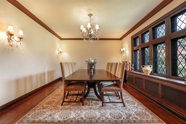 dining room featuring radiator, dark hardwood / wood-style flooring, crown molding, a textured ceiling, and an inviting chandelier