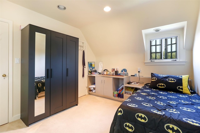 bedroom with vaulted ceiling and carpet flooring