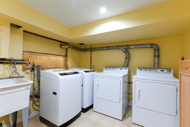 laundry room featuring washing machine and dryer and sink