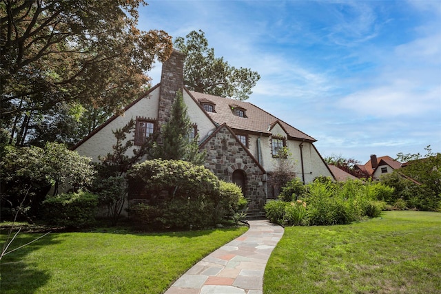 tudor home with a front yard