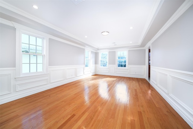 empty room with recessed lighting, a wainscoted wall, crown molding, and light wood-style flooring