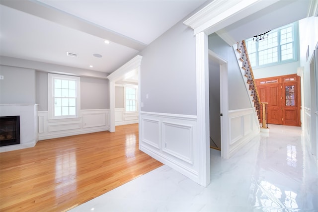 interior space with light wood-style flooring, recessed lighting, a premium fireplace, visible vents, and stairs