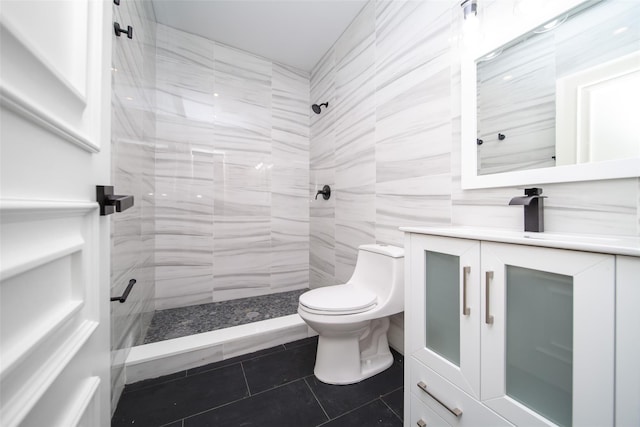 bathroom featuring toilet, a shower stall, tile patterned flooring, and vanity