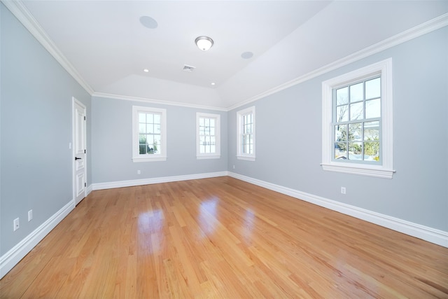 unfurnished room with ornamental molding, light wood-type flooring, visible vents, and baseboards