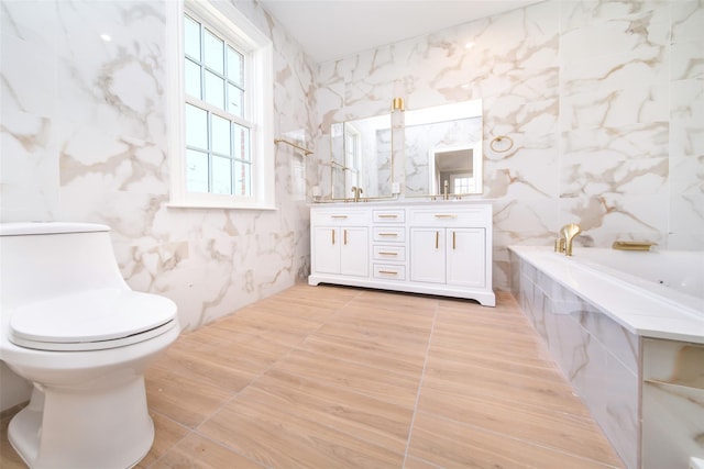 full bathroom featuring double vanity, a garden tub, tile walls, and a sink