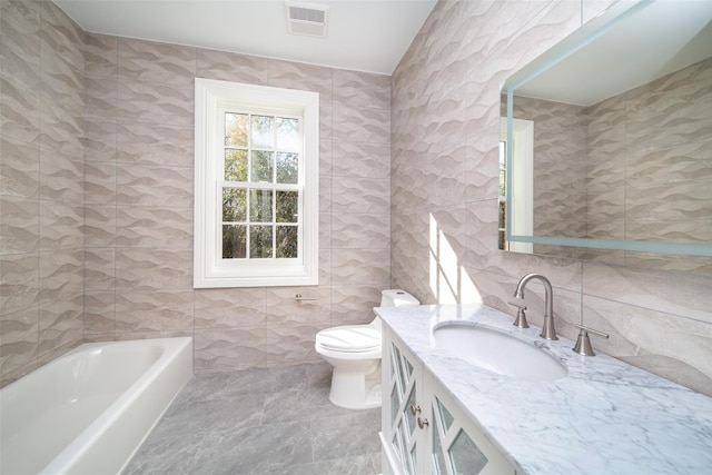 full bath with toilet, a bathtub, visible vents, and tile walls