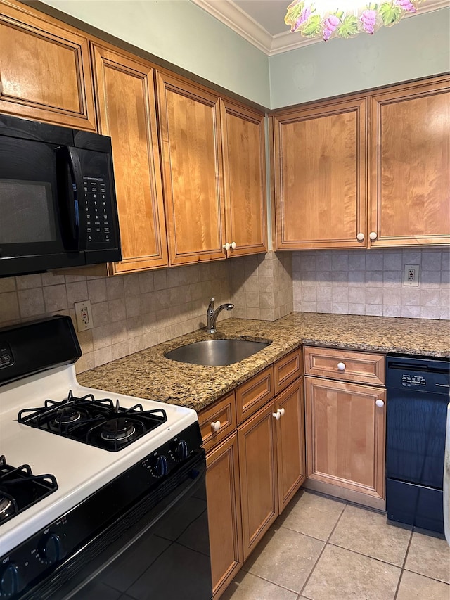 kitchen featuring tasteful backsplash, sink, ornamental molding, black appliances, and light stone countertops