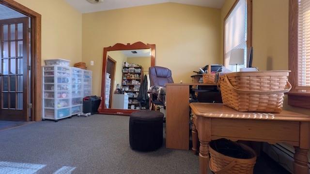 interior space with lofted ceiling, a wealth of natural light, and carpet flooring