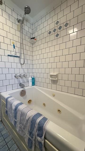 bathroom featuring tile patterned flooring and tiled shower / bath