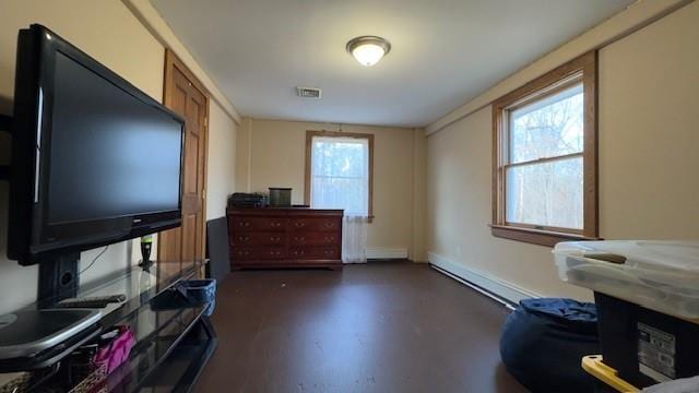 miscellaneous room with a healthy amount of sunlight and dark hardwood / wood-style flooring