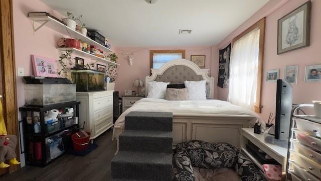 bedroom with dark hardwood / wood-style flooring