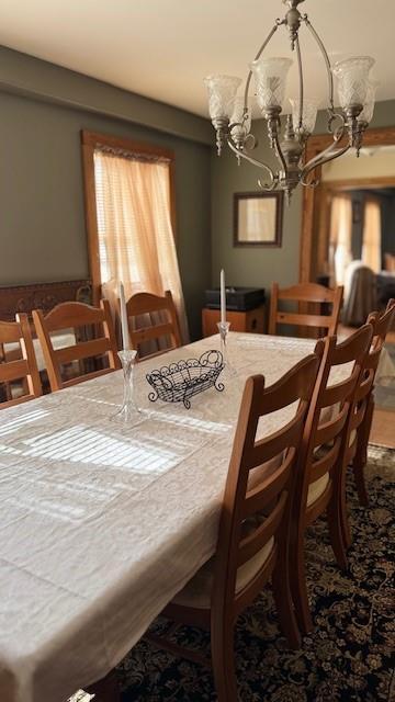 dining space featuring a chandelier