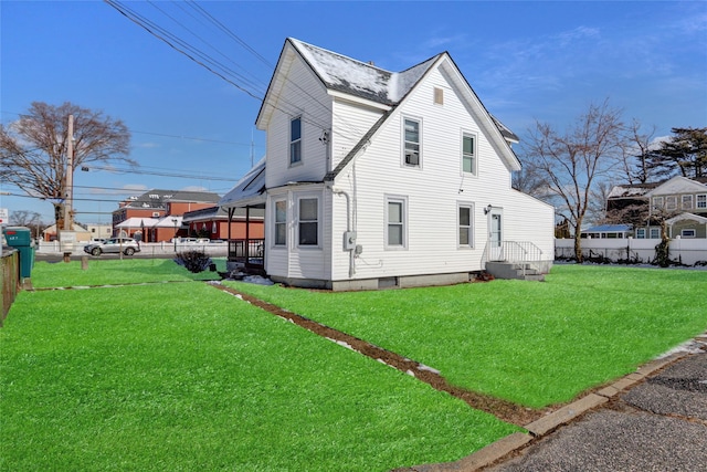 view of side of home featuring a lawn