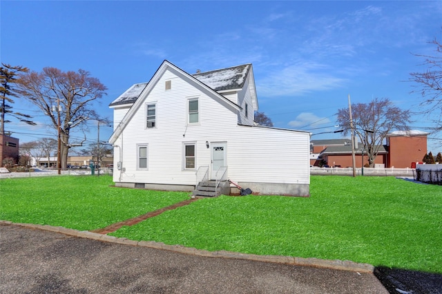 back of house featuring a lawn