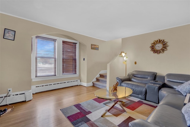 living room with a baseboard radiator and light hardwood / wood-style flooring