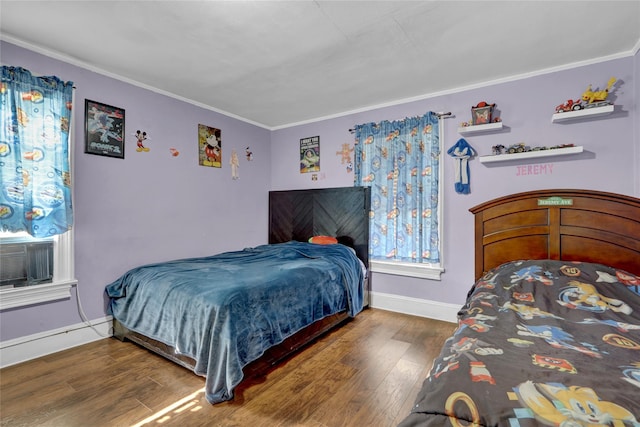 bedroom featuring ornamental molding and dark hardwood / wood-style floors