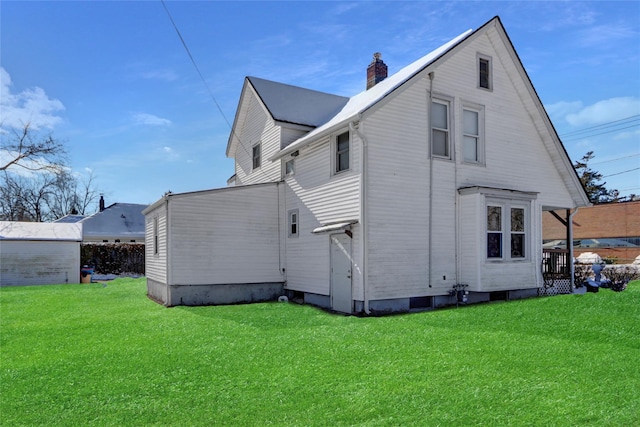 rear view of house with a yard