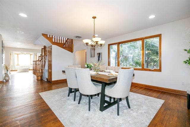 dining room featuring dark hardwood / wood-style flooring and a chandelier